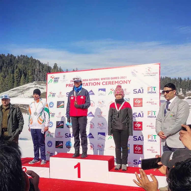 Bhavani Thekkada on the top step of the podium at the second Khelo India National Winter Games presentation ceremony, the silver and bronze medallists either side of her.